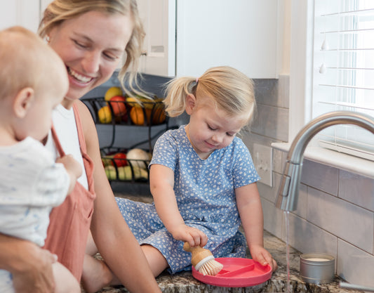 A Mother and two kids Cleaning using Bamboo Brush from A Clean Home Company Products, Natural Cleaning Products and Natural Cleaning solutions